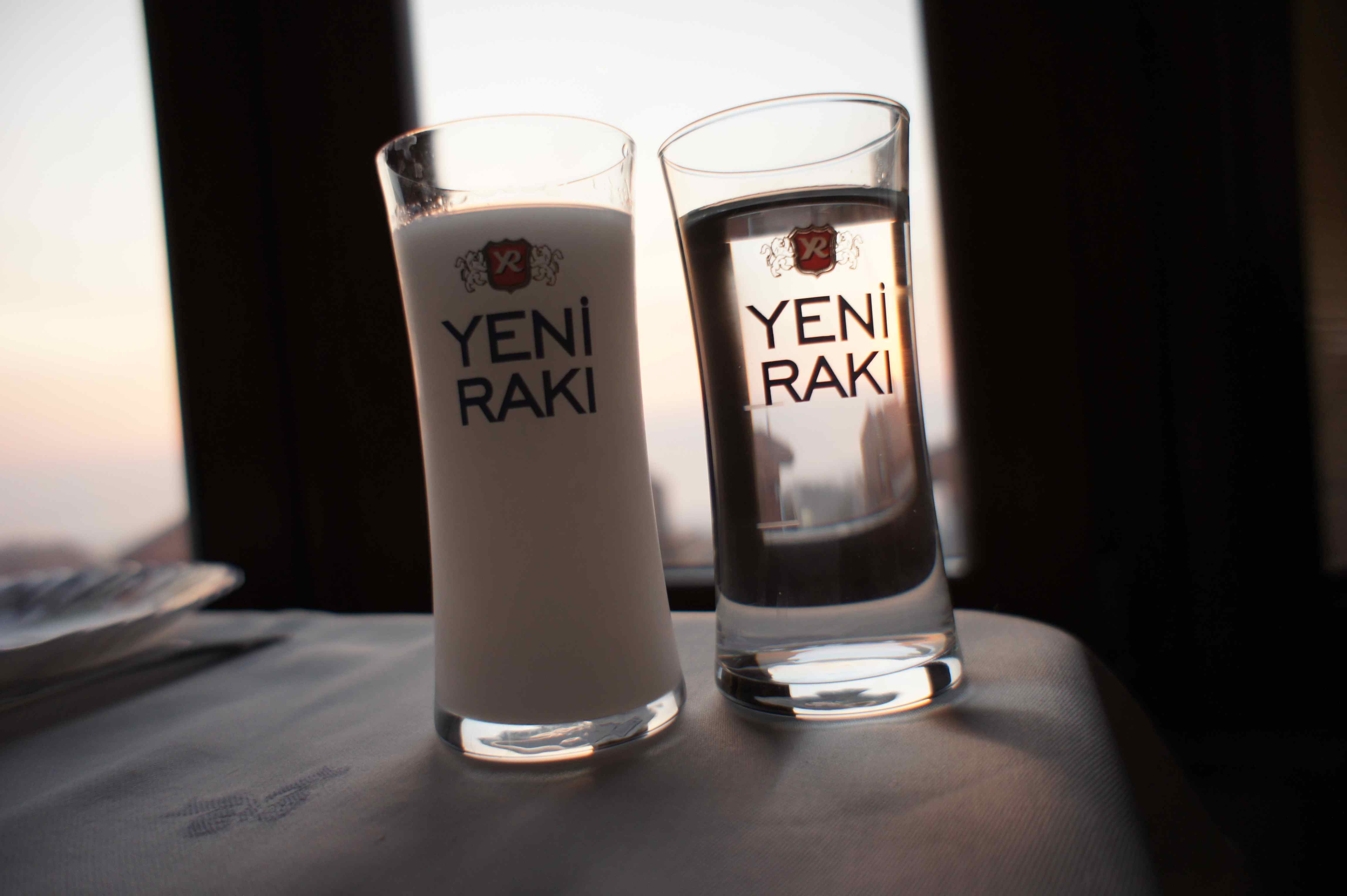 Raki in the left glass and cold water in the right one