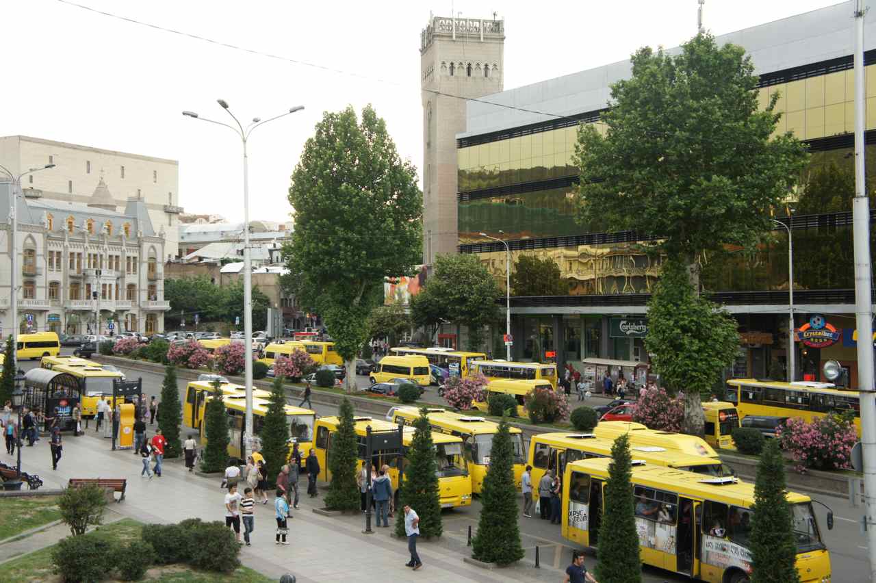 Yellow buses at a major bus stop