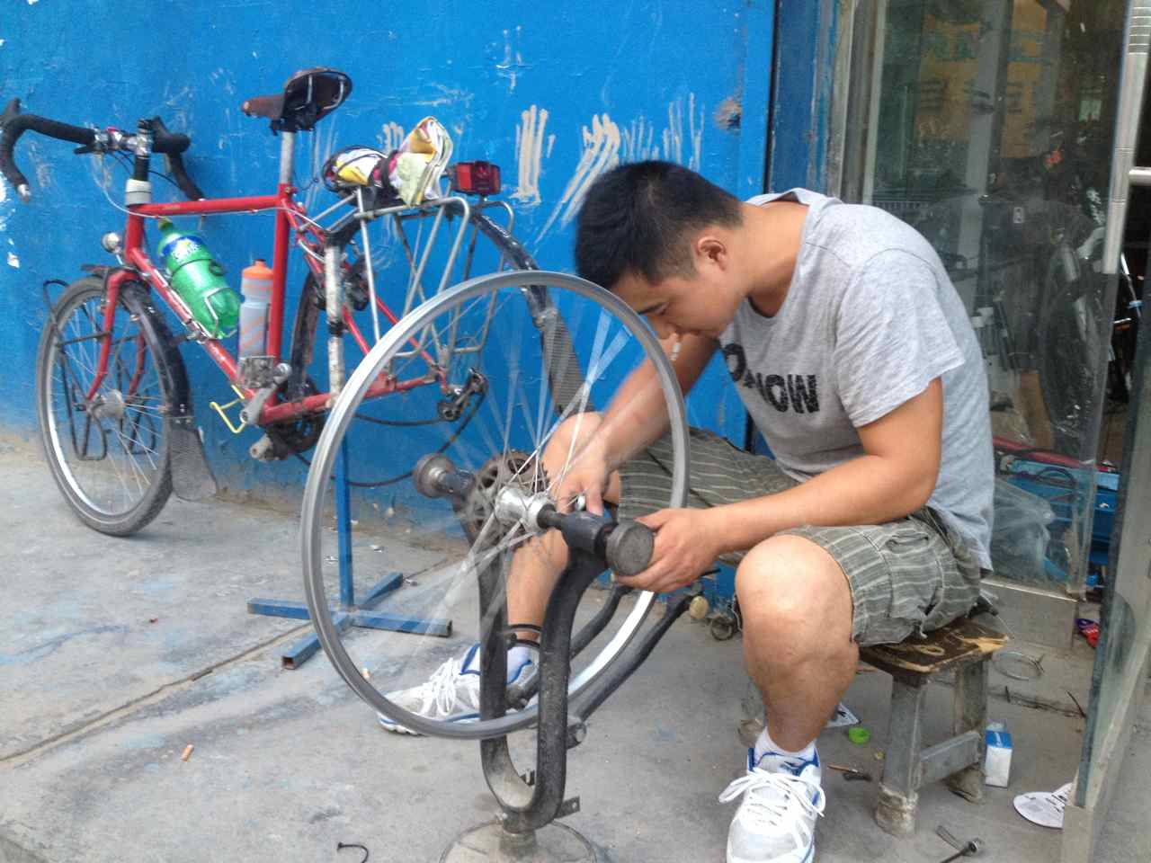 Getting my wheel trued at one of the 30 (!) bicycle shops in Korla